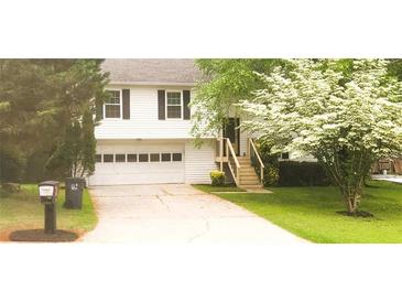 Charming two-story home featuring a well-manicured lawn and a two-car garage at 2811 Country Farms Ct, Snellville, GA 30039