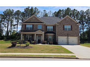 Charming brick two-story home with well-manicured lawn and attached two-car garage at 812 Graeme Dr, Mcdonough, GA 30252