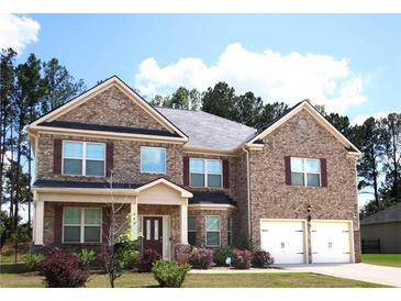 Charming two-story brick home with a well-maintained front yard and a two-car garage at 812 Graeme Dr, Mcdonough, GA 30252