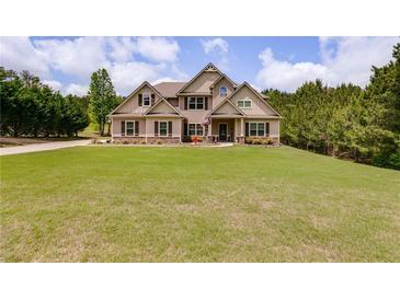 Attractive home featuring well-manicured lawn and traditional architecture at 127 Grayson Myers Dr, Villa Rica, GA 30180