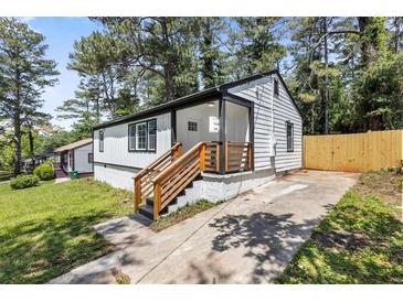 Charming renovated home featuring freshly painted siding, wooden stairs, and a well-maintained front yard at 4134 Burgess Dr, Decatur, GA 30035