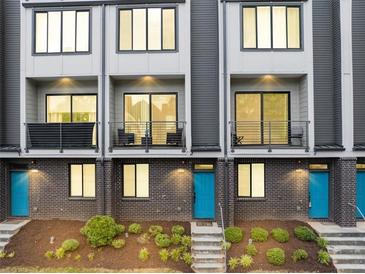 Beautiful townhome featuring brick facade, private balconies, and eye-catching, bright blue doors at 701 Pryor Sw St # 5, Atlanta, GA 30315