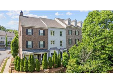 Beautiful townhome with brick and siding, a manicured front yard and a two car garage at 1914 Forte Ln, Alpharetta, GA 30009