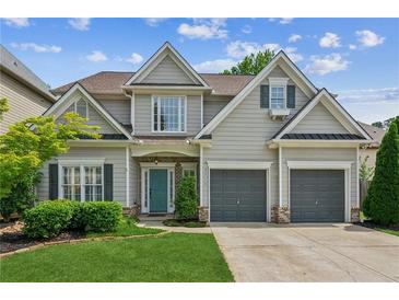 Charming two-story home with a well-manicured lawn, inviting curb appeal and an attached two-car garage at 2713 Stillwater Lake Ln, Marietta, GA 30066