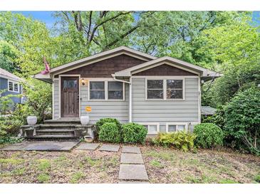 Charming home with a well-maintained lawn and inviting front entrance at 677 Holmes Nw St, Atlanta, GA 30318