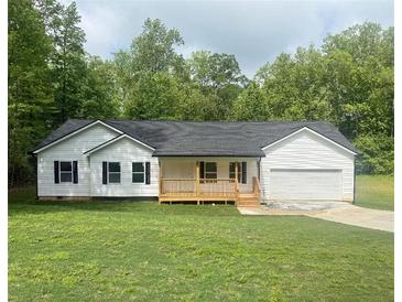 Charming single-story home with white siding, black shutters, a front porch, attached garage, and a well-maintained lawn at 201 Deerfield Ln, Carrollton, GA 30116