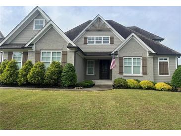 Charming home with a well-manicured lawn and a mix of brick and siding exterior at 312 Archway Ln, Peachtree City, GA 30269