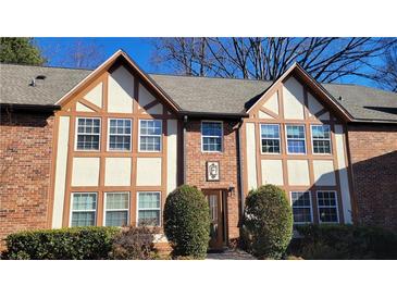 Charming two-story brick townhome featuring Tudor-style accents and well-manicured landscaping at 2825 Northeast Ne Expy # F3, Atlanta, GA 30345