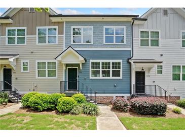 Charming townhome showcasing colorful siding, manicured landscaping, and a welcoming front entrance at 3760 Oxford Cir, Doraville, GA 30340