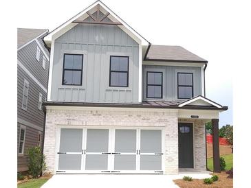 Charming two-story home with a brick-and-siding facade and integrated garage at 1058 Crest Mill Dr, Marietta, GA 30008