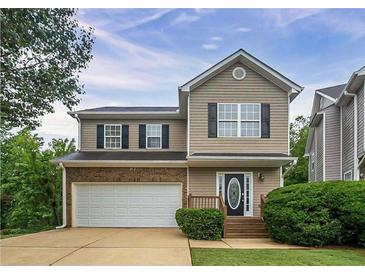 Charming two-story home featuring a front-facing garage, a covered entryway, and manicured landscaping at 107 Providence Run, Dallas, GA 30157