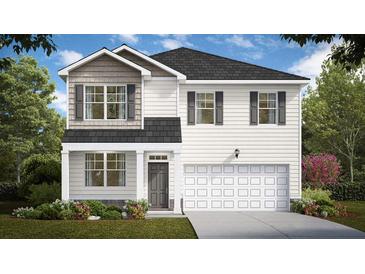 Charming two-story home featuring a two-car garage and beautifully landscaped front yard at 358 Friendship Oak Way, Hampton, GA 30228