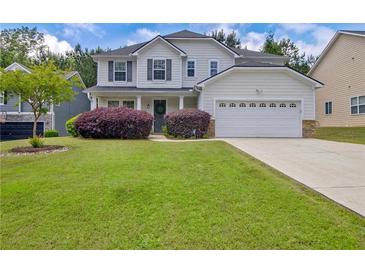 Charming two-story home with a well-manicured lawn, landscaping, and a two-car garage at 2951 Edgewater St, South Fulton, GA 30331