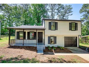 Charming two-story home with a covered front porch and a built-in garage at 3959 Wood Path Dr, Stone Mountain, GA 30083