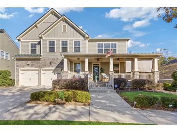 Charming two-story home featuring a covered front porch, stone accents, and a two-car garage at 3213 Blackley Old Rd, Douglasville, GA 30135
