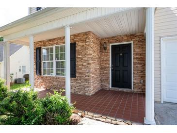Inviting front porch featuring stone accents, neutral-colored columns, and a tile floor at 45 Waterloo Ct, Hiram, GA 30141