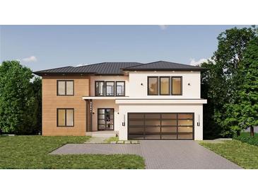 Modern two-story home featuring a contemporary design, a large garage, and a meticulously landscaped front yard at 4109 Abbotts Bridge Rd, Duluth, GA 30097