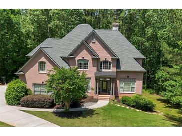 Stunning brick home features a well-manicured lawn with mature trees for added privacy at 1029 Laurel Grove Cts, Suwanee, GA 30024
