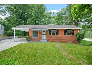 Charming one-story brick home with a carport and well-maintained front lawn at 3698 Fairlane Nw Dr, Atlanta, GA 30331