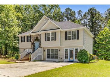Charming two-story home featuring a welcoming entryway, neutral siding, and a well-maintained front yard surrounded by mature trees at 3835 Annandale Ln, Suwanee, GA 30024