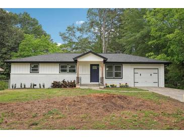 Charming, renovated single-story home with white brick and siding, complemented by a well-manicured front lawn at 1340 Juneau Ct, Tucker, GA 30084