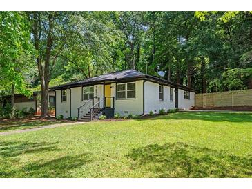 Charming, renovated single-story home with a freshly painted exterior and manicured front yard at 1678 Capistrana Pl, Decatur, GA 30032