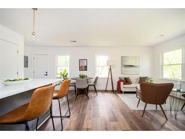 Open-concept living room features modern finishes, hardwood floors, and bright natural light at 1678 Capistrana Pl, Decatur, GA 30032