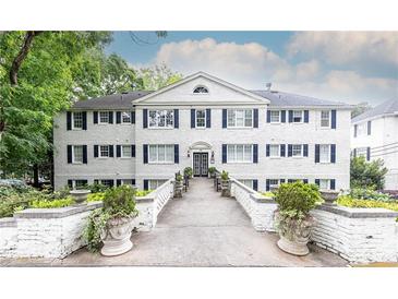 Charming white-painted three-story building with symmetrical window and shutter design at 35 Sheridan Ne Dr # 7, Atlanta, GA 30305
