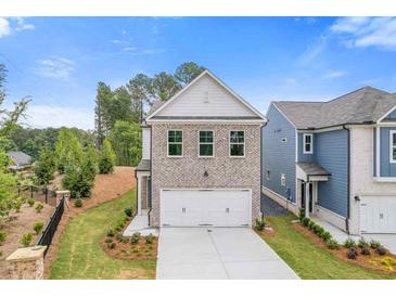 Beautiful two story home with brick and siding, well maintained landscaping, and attached two car garage at 1954 William Glen St, Dacula, GA 30019
