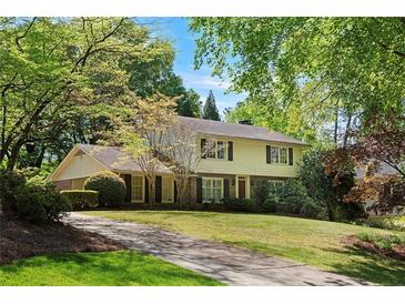 Charming two-story home featuring a well-manicured lawn and a long driveway at 4261 Brookview Se Dr, Atlanta, GA 30339