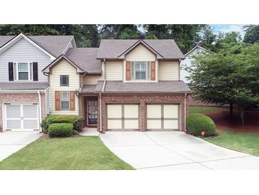 Charming home with a well-manicured lawn, a two-car garage, and beautiful exterior detailing at 989 Brownstone Ln # 16, Marietta, GA 30008