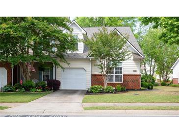 Charming home exterior with a well-manicured lawn and attached garage at 2410 Clock Face Ct, Lawrenceville, GA 30043