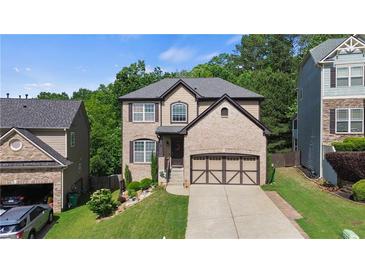 Charming two-story home with a well-manicured lawn, a two-car garage, and attractive landscaping at 456 Crestmont Ln, Canton, GA 30114