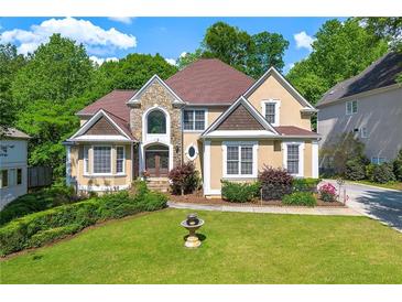 Stunning two-story home featuring a stone facade and manicured front lawn at 5309 Ashley Trce, Atlanta, GA 30360