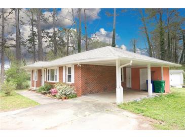 Charming single-story brick home with a convenient carport and well-maintained landscaping at 1693 Montreal Rd, Tucker, GA 30084