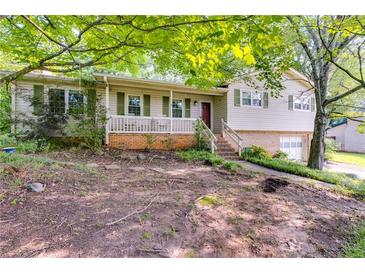 Charming home featuring a quaint front porch with green shutters, creating a welcoming facade at 230 King Arthur Dr, Woodstock, GA 30189