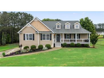 Charming single-Gathering home featuring a well-manicured lawn, lovely landscaping, and a welcoming front porch at 137 Cambridge Pointe, Villa Rica, GA 30180