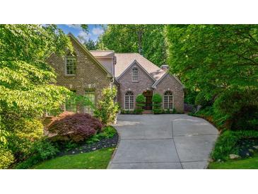 Charming brick home with mature trees and a long, inviting driveway at 1255 Beech Haven Ne Rd, Atlanta, GA 30324