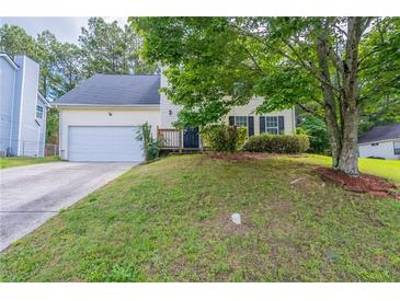 Charming two-story home with a well-manicured front yard and attached two-car garage at 3075 Oakvale Hts, Decatur, GA 30034