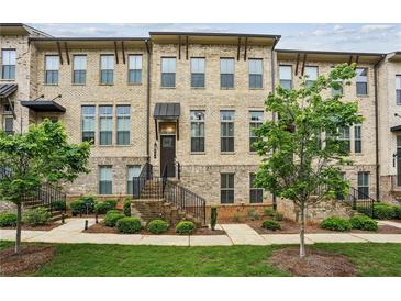 Charming brick townhouse with well-manicured lawn and landscaped front yard at 631 Avondale Creek Dr, Decatur, GA 30032