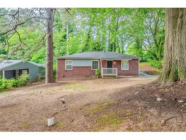 Charming brick home featuring a cozy front porch and surrounded by mature trees at 3731 Adkins Nw Rd, Atlanta, GA 30331