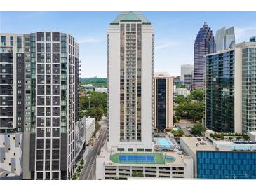 High-rise building featuring a rooftop pool and tennis court, perfect for luxury living with stunning city views at 1280 W Peachtree Nw St # 1013, Atlanta, GA 30309
