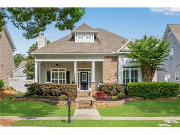 Charming home with stone accents, manicured landscaping, and a welcoming front porch perfect for relaxing at 753 Cambron Commons Trce, Suwanee, GA 30024