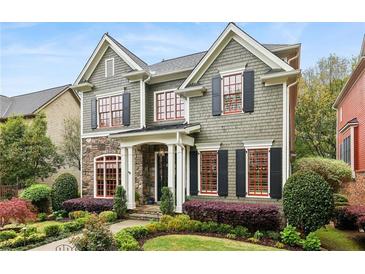 Charming two-story home with manicured lawn, stone accents, and inviting architectural details at 963 Manor Parc Dr, Decatur, GA 30033