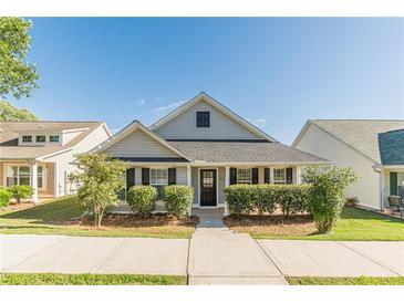 Charming single-story home with manicured landscaping and inviting front porch at 363 Chadwick Cmn, Stockbridge, GA 30281