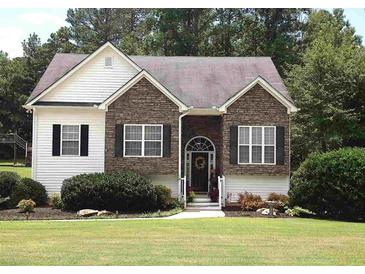 Charming single-Gathering home with stone and siding, featuring a well-manicured lawn and inviting front entrance at 100 Sydney Smt, Villa Rica, GA 30180