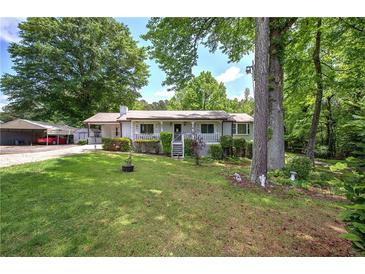 Charming single-story home featuring a cozy front porch and a well-maintained lawn with mature trees at 1095 Dallas Nebo Rd, Dallas, GA 30157