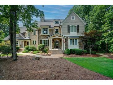 Charming stone and shingle home featuring a landscaped front yard and inviting entrance at 118 Whitestone Dr, Mcdonough, GA 30253