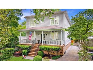 Charming two-story home boasts a welcoming front porch, landscaped yard, and classic architectural details at 66 Mobile Ne Ave, Atlanta, GA 30305