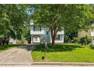 Charming two-story home with well-maintained lawn and mature trees at 5250 Forest Downs Ln, Atlanta, GA 30349